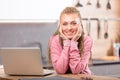 Young smiling woman sitting next to laptop Royalty Free Stock Photo