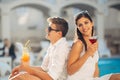 Loving couple spending vacation on tropical resort swimming pool.Newlyweds honeymoon on seaside Royalty Free Stock Photo