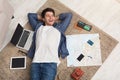 Man dreaming about travel, lying on floor Royalty Free Stock Photo