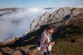 Young man taking photographs with digital camera in a mountains. Royalty Free Stock Photo