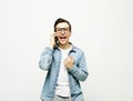 young cheerful man standing isolated over white background, using mobile phone Royalty Free Stock Photo