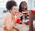 Young cheerful mixed race businesswoman eating lunch with hr colleagues at work. Group of joyful coworkers having pizza Royalty Free Stock Photo