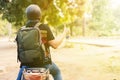 Young cheerful and positive male motorcyclist riding on motorbike on the country street.