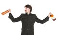 Young cheerful priest with bottle of alcohol isolated Royalty Free Stock Photo