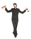 Young cheerful priest with bottle of alcohol isolated Royalty Free Stock Photo