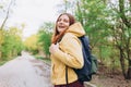 Young cheerful redhaired woman enjoying spring day in park. Young woman hiking and going camping in nature. Person with