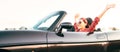 Young cheerful smiling female driving convertible car at sunny day time headers web site