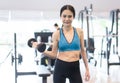 Young cheerful smiling woman exercising with dumbbells in gym ,Fitness Concept,Healthy Lifestyle and people concept. Royalty Free Stock Photo