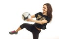 Young cheerful sportswoman in black kicks a soccer ball kicked Royalty Free Stock Photo