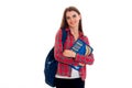 Young cheerful student girl with backpack posing isolated on white background in studio Royalty Free Stock Photo