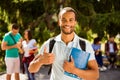 Young cheerful successful african nerdy student is showing thumb