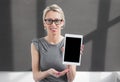 Young cheerful teacher showing tablet computer