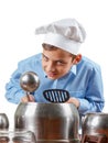 Young cheerful teenager humor in a chef's hat. He plays the drums, pots. Isolated studio Royalty Free Stock Photo