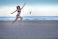 Young cheerful woman in bikini jumping on the beach. Royalty Free Stock Photo