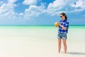 Young cheerful woman with coconut against turquoise sea Royalty Free Stock Photo