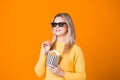 Young cheerful woman in 3D glasses watching a blockbuster and eating popcorn. Royalty Free Stock Photo