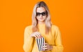 Young cheerful woman in 3D glasses watching a movie and eating popcorn. Royalty Free Stock Photo