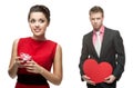 Young cheerful woman and handsome man holding red heart on white Royalty Free Stock Photo