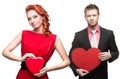 Young cheerful woman and handsome man holding red heart on white Royalty Free Stock Photo