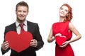 Young cheerful woman and handsome man holding red heart on white Royalty Free Stock Photo