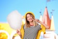 Young cheerful woman having fun with cotton candy in park Royalty Free Stock Photo