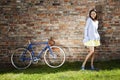 Young cheerful woman and old blue bike Royalty Free Stock Photo
