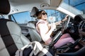 Sports woman driving a car Royalty Free Stock Photo