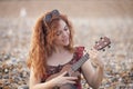 Young cheerful woman playing ukelele i Royalty Free Stock Photo