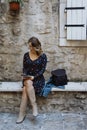 Young cheerful woman reading an e-book in old town Royalty Free Stock Photo