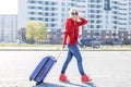 Young cheerful woman with a suitcase. The concept of travel, work, lifestyle.