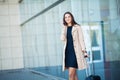 Young Cheerful Woman With a Suitcase. The Concept of Travel, Work, Lifestyle