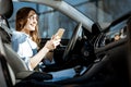 Woman with phone in the car Royalty Free Stock Photo