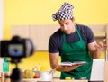 Young chef blogger explaining food preparation Royalty Free Stock Photo