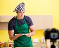 Young chef blogger explaining food preparation Royalty Free Stock Photo