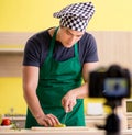 Young chef blogger explaining food preparation Royalty Free Stock Photo