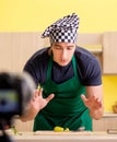 Young chef blogger explaining food preparation Royalty Free Stock Photo