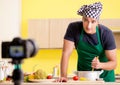 Young chef blogger explaining food preparation Royalty Free Stock Photo