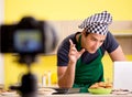 Young chef blogger explaining food preparation Royalty Free Stock Photo