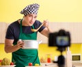 Young chef blogger explaining food preparation Royalty Free Stock Photo