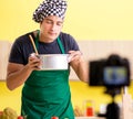 Young chef blogger explaining food preparation Royalty Free Stock Photo