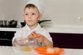 Young chef breaking eggs into bowl Royalty Free Stock Photo
