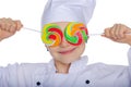 Young chef closed his eyes colored candies