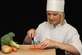 Young chef cutting carrots