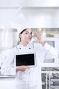 Young chef with deliciousness gesture and tablet Royalty Free Stock Photo