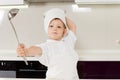 Young chef fencing with his stainless steel ladle Royalty Free Stock Photo