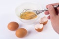 Whisking Delight: Young Chef Hand Whisking Chicken Eggs in a Ceramic Bowl Royalty Free Stock Photo