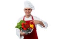 Young chef holding vegetables bowl