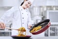 Young chef making fried noodle Royalty Free Stock Photo