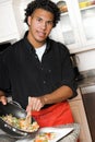 Young chef plating food