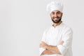 Young chef posing isolated over white wall background in uniform